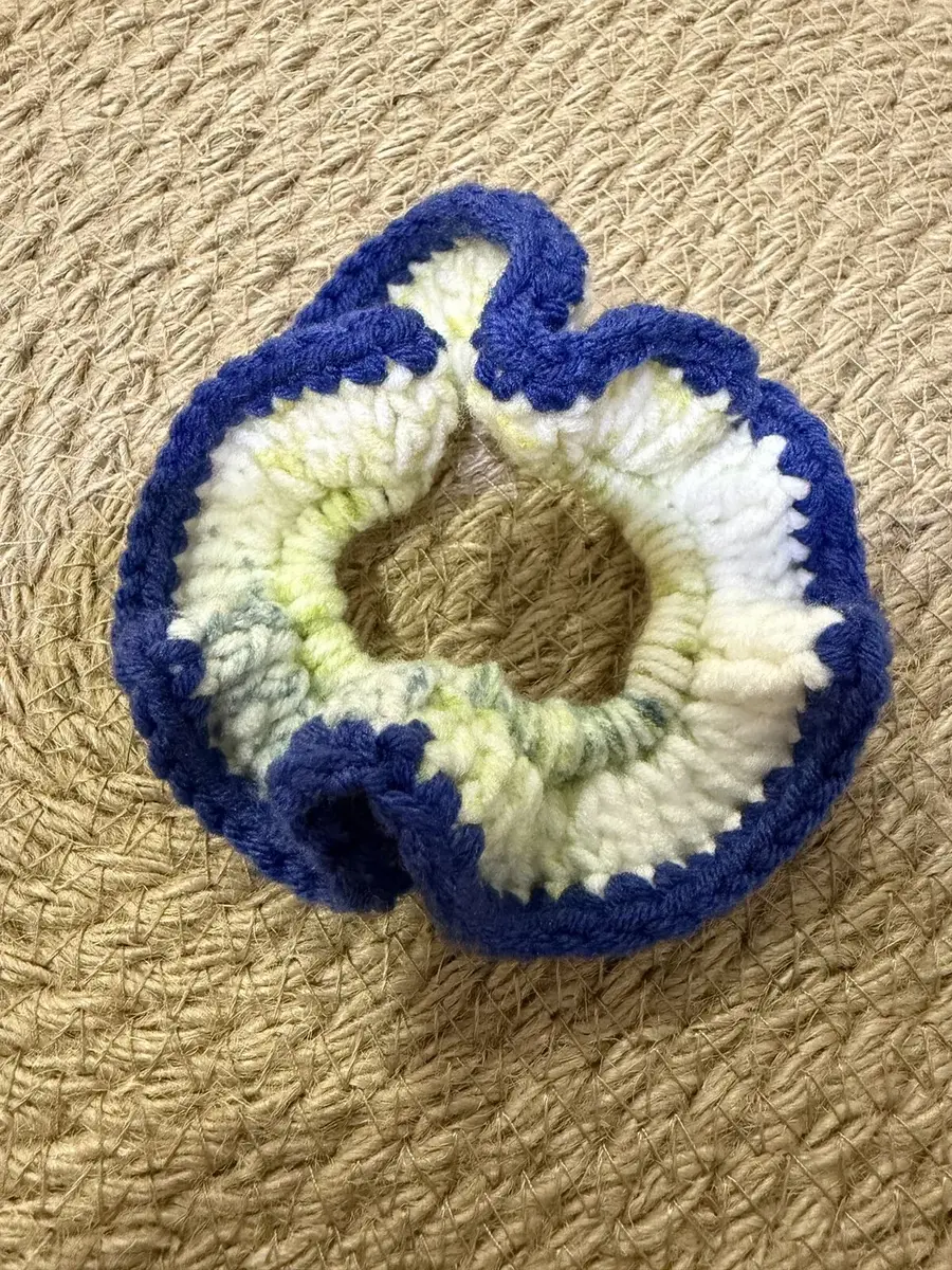 A handmade ruffle scrunchie in navy and cream.